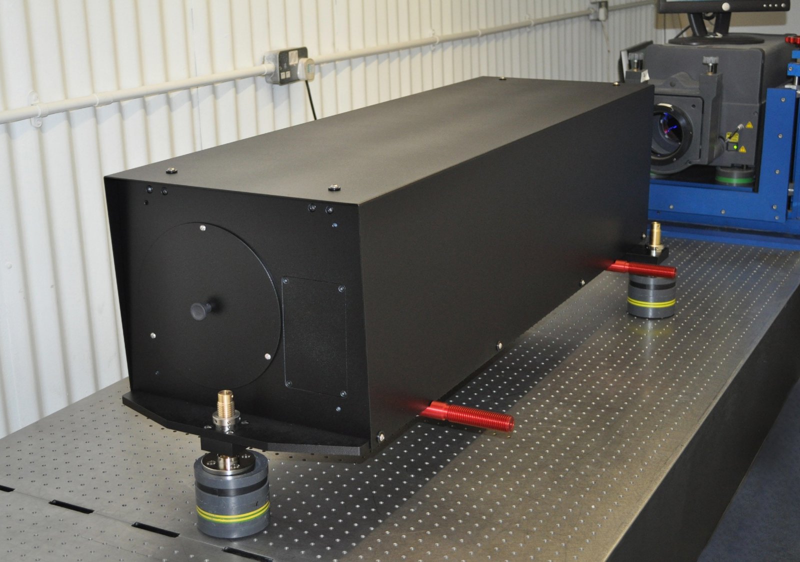 The 250mm aperture (1.5m focal length) beam aiming system is fully assembled on an optical table.